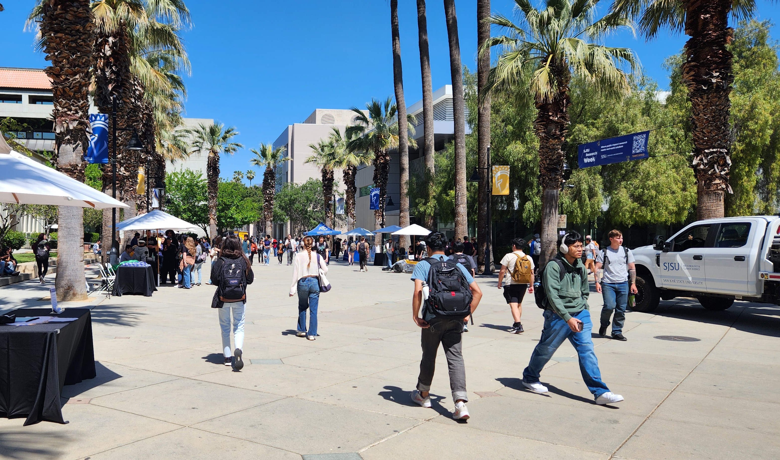 Students walking along the Paseo on a sunny day
