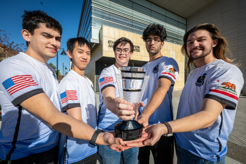Members of SJSU’s esports team posing with a trophy.
