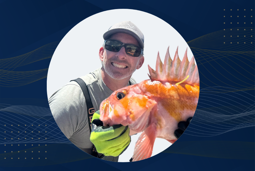 Professor Scott Hamilton holding a fish.